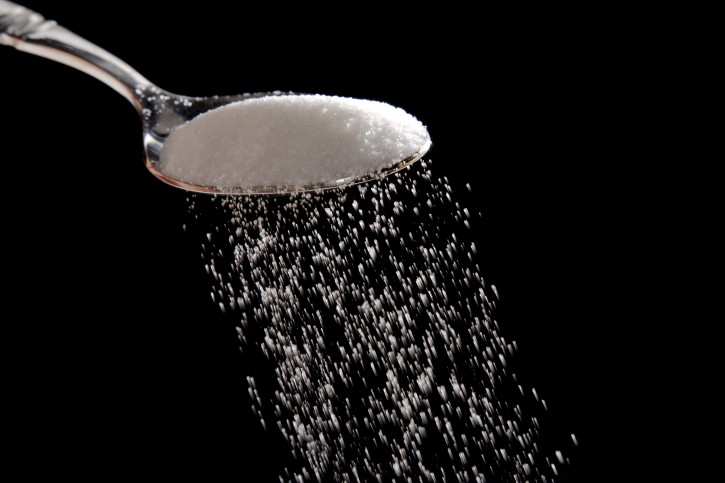 Granulated sugar is poured in Philadelphia, Monday, Sept. 12, 2016. A new study released Monday details how the sugar industry worked to downplay emerging science linking sugar and heart disease. It's the latest installment of an ongoing project by a former dentist to reveal the industry's decades-long attempt to influence science. (AP Photo/Matt Rourke)