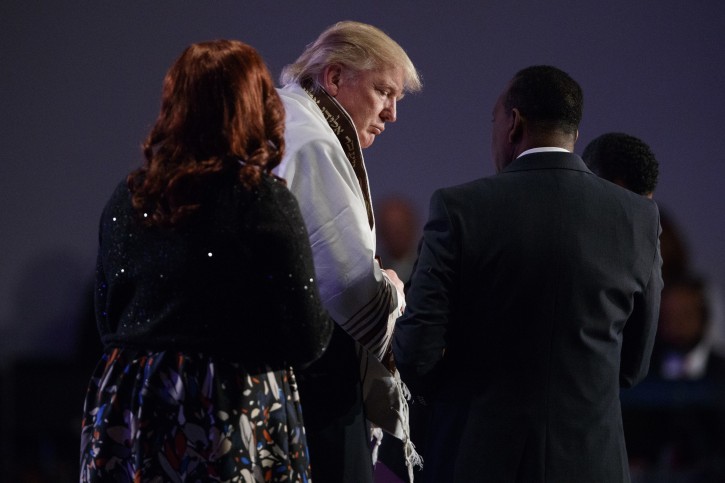 Republican presidential candidate Donald Trump wears a prayer shawl during a church service at Great Faith Ministries, Saturday, Sept. 3, 2016, in Detroit. (AP Photo/Evan Vucci)