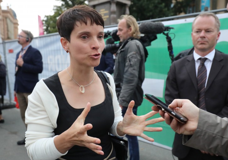 AfD  (Alternative for Germany) party chairwoman,  Frauke Petry,  speaks with journalists after first exit polls for the state elections in Mecklenburg-Western Pomerania,  , in Schwerin,  Germany, Sunday Sept. 4, 2016. The exit polls for ARD and ZDF public television put support for Alternative for Germany, or AfD, in Sunday's election for the state legislature in Mecklenburg-Western Pomerania around 21 percent. They put support for Merkel's Christian Democrats at 19 or 20 percent.  (Christian Charisius/dpa  via AP)