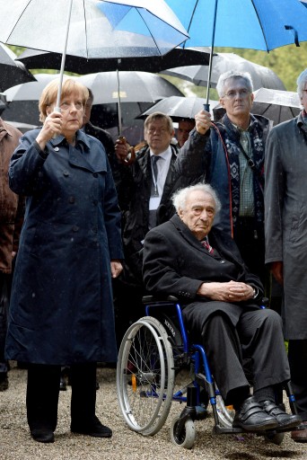 FILE - In this May 3, 2015 file photo German Chancellor Angela Merkel, left, and Holocaust survivor Max Mannheimer attend a ceremony marking the 70th anniversary of the Dachau concentration camp in Dachau, southern Germany. Mannheimer died Friday, Sept. 23, 2016. He was 96.  (Andreas Gebert/pool photo via AP, file)