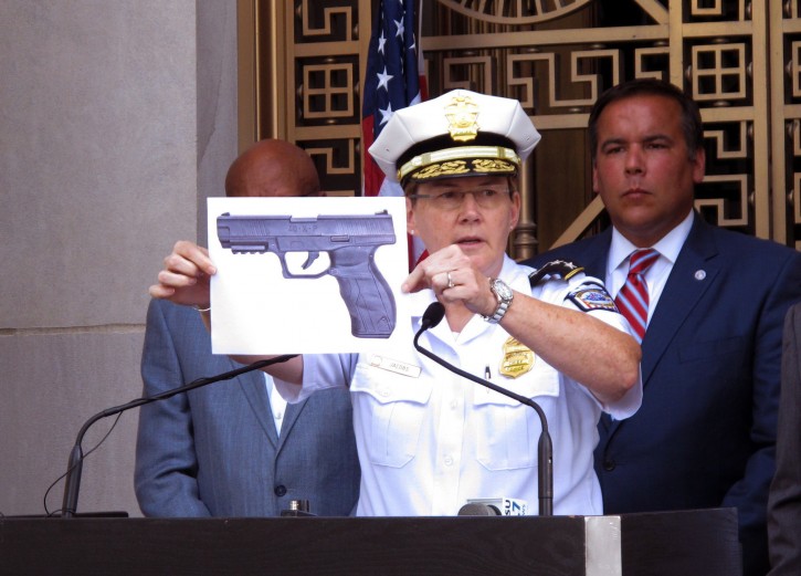 FILE - In this Thursday, Sept. 15, 2016, file photo, Columbus, Ohio, Police Chief Kim Jacobs displays a photo of the type of BB gun police say 13-year-old Tyre King pulled from his waistband before he was shot and killed by a police officer investigating an armed robbery report, during a news conference in Columbus, Ohio. (AP Photo/Andrew Welsh-Huggins, File)