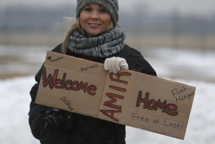 FILE - Flint resident Stephanie Walker holds a 'Welcome Home' sign outside the airport where former U.S. Marine Amir Hekmati, recently released from an Iranian prison, arrived in Flint, Michigan January 21, 2016.      REUTERS/Rebecca Cook 