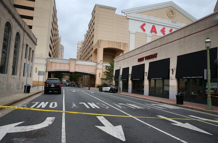 Police investigate the scene of a shooting on Saturday, Sept. 3, 2016 in Atlantic City, N.J.    Authorities say a New Jersey police officer remains in critical condition after he was shot during an exchange of gunfire outside an Atlantic City casino. Acting Atlantic County Prosecutor Diane Ruberton said  that the officer underwent surgery Saturday morning after the shoo ting that left one suspect dead. (Ben Fogletto /The Press of Atlantic City via AP)
