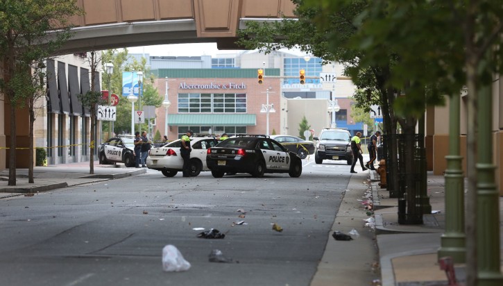 Police investigate the scene of a shooting on Saturday, Sept. 3, 2016 in Atlantic City, N.J.    Authorities say a New Jersey police officer remains in critical condition after he was shot during an exchange of gunfire outside an Atlantic City casino. Acting Atlantic County Prosecutor Diane Ruberton said  that the officer underwent surgery Saturday morning after the shooting that left one suspect dead. (Ben Fogletto /The Press of Atlantic City via AP