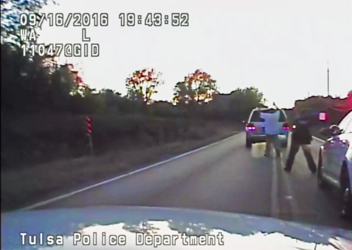 A frame grab from video released by the Tulsa, Oklahoma, USA, Police Department and acquired on 20 September 2016 reportedly shows Terence Crutcher (R) walking with his hands in the air as he is confronted by police after his automobile broke down in Tulsa, Oklahoma, USA, on 16 September 2016. EPA