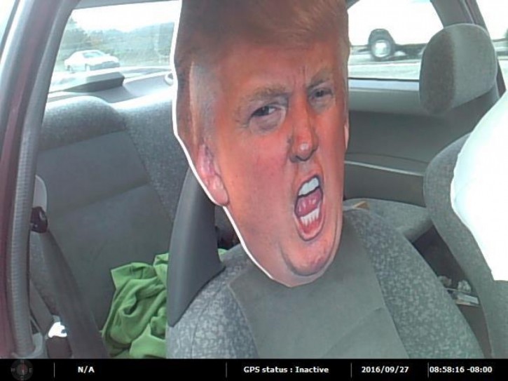 This photo provided by the Washington State Patrol shows a cardboard cutout of Republican presidential nominee Donald Trump's head in the passenger seat of a car Tuesday, Sept. 27, 2016, in Seattle. A trooper stopped the motorist who was driving with the cardboard likeness in a carpool lane south of Seattle on Highway 167. The stunt netted the driver a $136 ticket. (Washington State Patrol via AP)