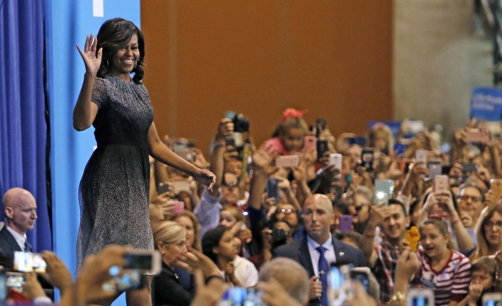 First lady Michelle Obama waves to supporters as she arrives on stage prior to speaking during a campaign rally for Democratic presidential candidate Hillary Clinton Thursday, Oct. 20, 2016, in Phoenix. (AP Photo/Ross D. Franklin)