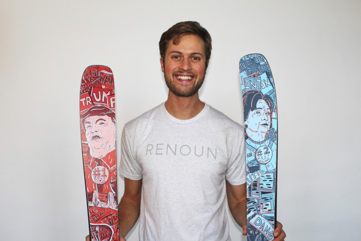In this photo provided by Renoun, CEO Cyrus Schenck, poses with a pair of skis featuring Hillary Clinton imagery, at right, and Donald Trump, at left. (Courtesy of Renoun via AP)