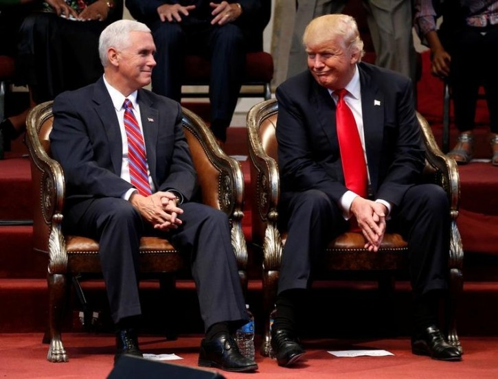 Republican presidential nominee Donald Trump (R) and vice presidential nominee Governor Mike Pence attend a gathering of pastors at the New Spirit Revival Center in Cleveland Heights, Ohio, U.S. September 21, 2016. REUTERS/Jonathan Ernst 