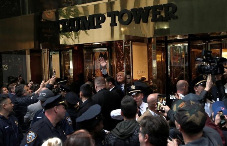 Republican presidential nominee Donald Trump waves to supporters outside the front door of Trump Tower where he lives in the Manhattan borough of New York, U.S., October 8, 2016.  REUTERS/Mike Segar   