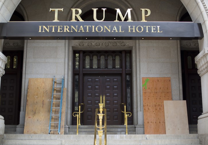 Plywood is leaned-up against the walls covering graffiti that was painted on the walls at the entrance to the Trump Hotel in downtown, Washington, Sunday, Oct. 2, 2016 in Washington. Trumpâs new luxury hotel in Washington has been vandalized. District of Columbia police say someone spray-painted the phrases âblack lives matterâ and âno justice no peaceâ on the front of building Saturday, afternoon. (AP Photo/Pablo Martinez Monsivais)