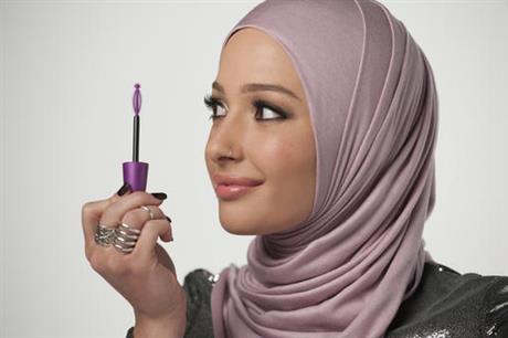In this undated photo provided by CoverGirl, beauty blogger Nura Afia poses for a photo. CoverGirl is featuring a woman wearing a hijab in its advertising for the first time in the makeup line’s history. (Lacey Terrell/CoverGirl via AP)