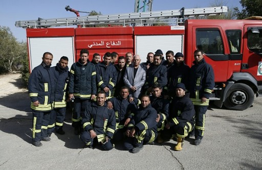 Palestinian firefighters pose for a photo in the village of Nataf close to Jerusalem, to help extinguish an ongoing fire in the area, on November 26, 2016. Wildfires near Jewish settlements in the occupied West Bank have forced hundreds to flee their homes, after mass evacuations in Israel and more than a dozen arrests, police said, while Israeli and Palestinian firefighters, helped by foreign aircraft, have been battling dozens of bush blazes fed by drought and high winds that have seen tens of thousands of people evacuated.  / AFP / AHMAD GHARABLI        (Photo credit should read AHMAD GHARABLI/AFP/Getty Images)