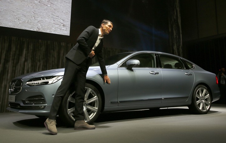 Thomas Ingenlath, Vice president of Volvo Cars design, shows a new S90 Volvo car in Shanghai, China Wednesday Nov. 2, 2016. Volvo Cars and its Chinese owner are revving up their profile as they focus on selling premium cars in world markets. The companies announced a strategy Wednesday that includes a new factory to make vehicles based on a new shared platform, including vehicles for Geely's new "connected car" brand, Lynk & Co.(AP Photo)