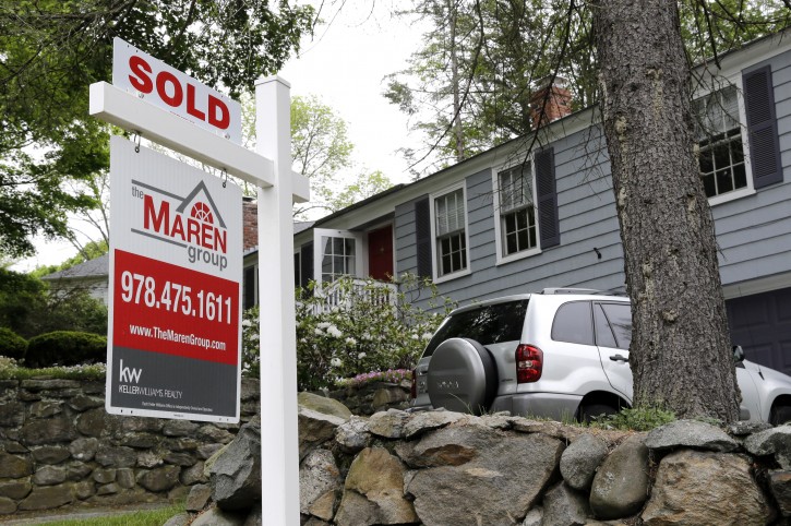 FILE - In this May 24, 2016 file photo, a "Sold" sign is placed front of a house in Andover, Mass. On Thursday, Nov. 17, 2016, Freddie Mac reports on the week's mortgage rates. (AP Photo/Elise Amendola, File)