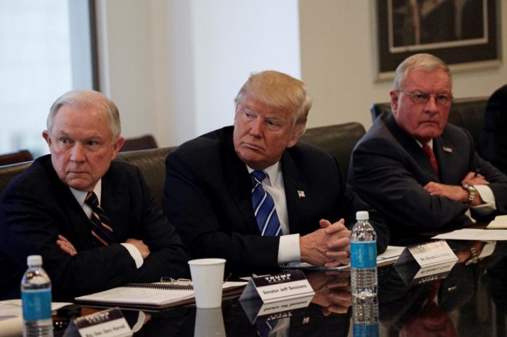 Republican presidential nominee Donald Trump sits with U.S. Senator Jeff Sessions (R-AL) (L) and retired U.S. Army General Keith Kellogg (R) during a national security meeting with advisors at Trump Tower in Manhattan, New York, U.S., October 7, 2016.  REUTERS/Mike Segar