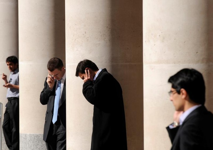 City workers make phone calls outside the London Stock Exchange in Paternoster Square in the City of London, Britain, October 1, 2008.  REUTERS/Toby Melville/File Photo 