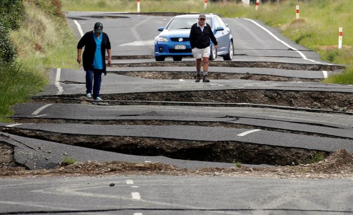 Local residents Chris and Viv Young look at damage caused by an earthquake, along State Highway One near the town of Ward, south of Blenheim on New Zealand's South Island, November 14, 2016. REUTERS/Anthony Phelps 