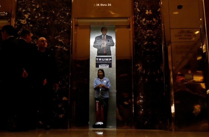 A worker yawns as the elevator doors close in the lobby of Republican president-elect Donald Trump's Trump Tower in New York, New York, U.S. November 14, 2016. REUTERS/Carlo Allegri