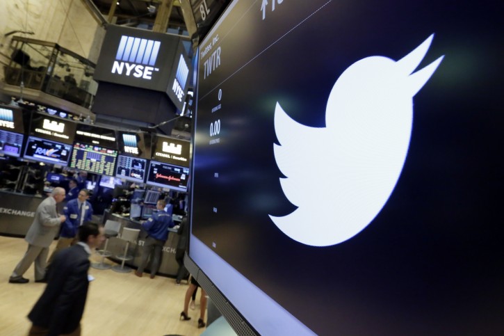 FILE - In this July 27, 2016, file photo, the Twitter symbol appears above a trading post on the floor of the New York Stock Exchange.  Twitter, long criticized as a hotbed for online harassment, is expanding ways to curb the amount of abuse users see and making it easier to report such conduct. (AP Photo/Richard Drew, File)