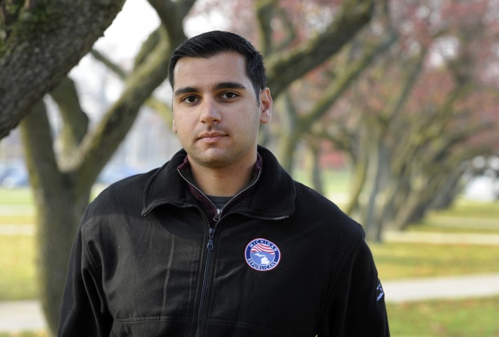 In a photo from Thursday, Nov. 17, 2016, Oakland University senior Michael Banerian stands on campus in Rochester, Mich. Banerian, a Republican representative to the Electoral College has been receiving death threats. (AP Photo/Jose Juarez)