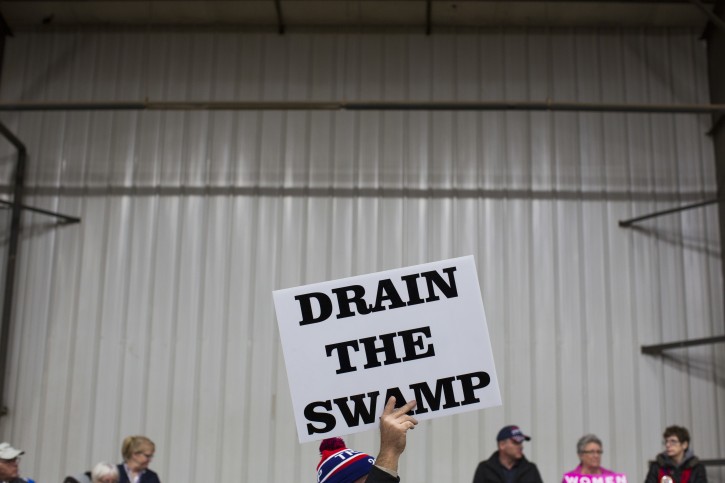 FILE - In this Oct. 27, 2016, file photo, supporters of then-Republican presidential candidate Donald Trump hold signs during a campaign rally in Springfield, Ohio. President-elect Donald Trumpâs campaign promise to âdrain the swampâ of Washington might make it difficult for him to fill all the jobs in his administration. (AP Photo/ Evan Vucci, file)