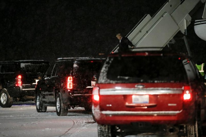 U.S. President-elect Donald Trump disembarks from his plane and to a waiting motorcade in the snow after landing in Grand Rapids, Michigan, U.S. December 9, 2016.  REUTERS/Mike Segar