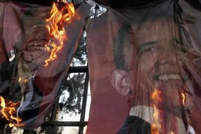 Hardline demonstrators burn posters of U.S. President-elect Barack Obama, during a demonstration in support of the people of Gaza, in front of the Swiss Embassy in Tehran January 13, 2009.