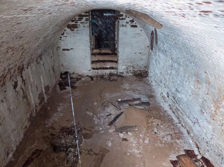 Burial Vault This Nov. 3, 2015 photo provided by the New York City Department of Design and Construction shows the inside of a centuries-old burial vault containing human remains beneath a street in New York's Greenwich Village neighborhood according to anthropologists and archeologists. Two vaults were discovered by workers replacing a water main in the heart of New York University's campus. One of the roughly 15-by-18-foot crypts contained skeletons and skulls of between 9 and 12 people pushed into a corner while more than a dozen stacked wooden coffins can be seen in the second one. (New York City Department of Design and Construction via AP)
