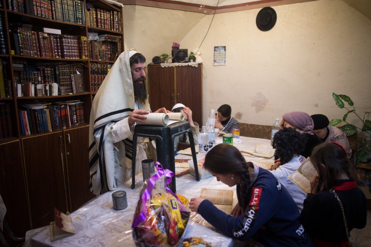 . FILE - Yolish Krauss, reading the Scroll of Esther at his house in the ultra orthodox Jewish neighborhood of Meah Shearim, during the Jewish holiday of Purim, March 25, 2016. Flash90