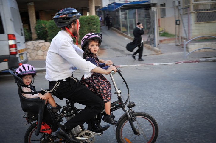 An ultra orthodox Jewish man rides an electric bike through the streets of the ultra orthodox Jewish town of Bnei Brak. October 01, 2017. Photo by Serge Attal/FLASH90