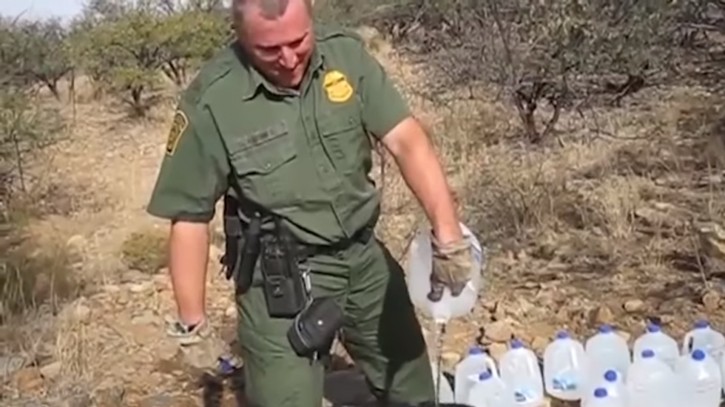 A video shows a border patrol agent pouring out water that a humanitarian aid group left at a desert camp for migrants illegally crossing the border.