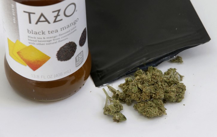 In this Thursday, Dec. 21, 2017 photo, a bottle of tea and marijuana from HighSpeed juice delivery service are displayed together, in Walpole, Mass. Companies like HighSpeed have been exploiting a provision in state marijuana laws that allows people to exchange up to an ounce of marijuana, so long as it's given away or "gifted" without any money exchanged. The tea was at least $60, but the marijuana was free. (AP Photo/Steven Senne)