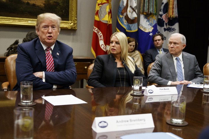 Florida Attorney General Pam Bondi, center, and Attorney General Jeff Sessions, right, look on as President Donald Trump speaks during a meeting with state and local officials to discuss school safety, in the Roosevelt Room of the White House, Thursday, Feb. 22, 2018, in Washington. (AP Photo/Evan Vucci)