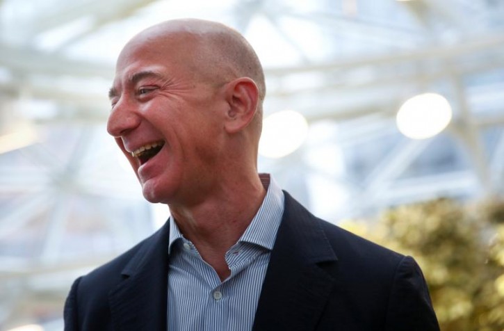 Amazon founder and CEO Jeff Bezos laughs as he talks to the media while touring the new Amazon Spheres during the grand opening at Amazon's Seattle headquarters in Seattle, Washington, U.S., January 29, 2018.   REUTERS/Lindsey Wasson 
