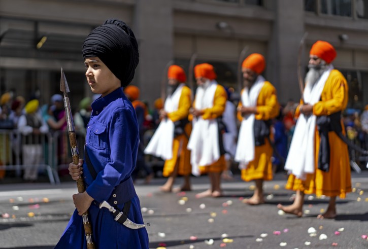 Bir Singh, 7, of Hicksville, N.Y., marches near the front of the Sikh Day Parade, an annual Nagar Keertan "meditation celebration" Saturday, April 28, 2018, in New York. (AP Photo/Craig Ruttle)