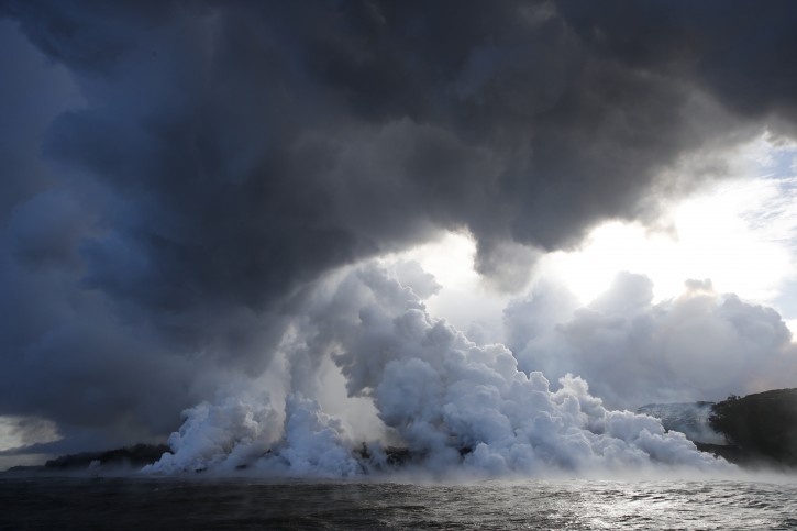 FILE  - In this May 20, 2018 file photo, plumes of steam rise as lava enters the ocean near Pahoa, Hawaii.  (AP Photo/Jae C. Hong, File)