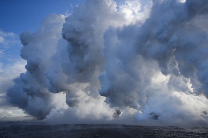 FILE - In this May 20, 2018 file photo, plumes of steam rise as lava enters the ocean near Pahoa, Hawaii.  (AP Photo/Jae C. Hong, File)