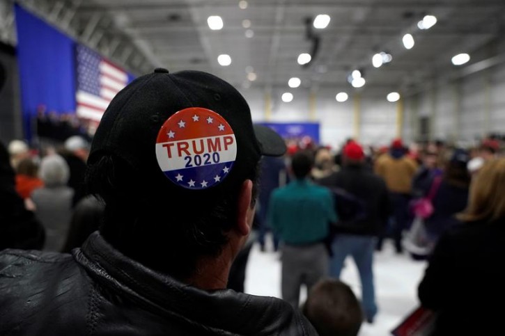 A man wears a Trump 2020 campaign button as U.S. President Donald Trump speaks in support of Republican congressional candidate Rick Saccone during a Make America Great Again rally in Moon Township, Pennsylvania, U.S., March 10, 2018.      REUTERS/Joshua Roberts 