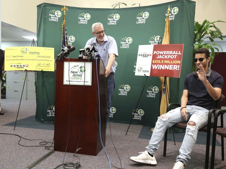 Tayeb Souami, left, of Little Ferry, introduces his son Inel during a press conference announcing Souami as the $351.3 million Powerball winner, Friday, June 8, 2018, in Trenton, N.J. (Chris Pedota/The Record via AP)