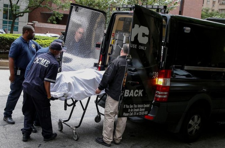 Medical examiners remove the body from the Park Avenue apartment of designer Kate Spade in New York, U.S. June 5, 2018. REUTERS/Brendan McDermid