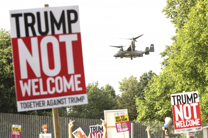 A helicopter leaves the grounds of the US ambassador residence in Regent's Park, London, while demonstrators protest against the visit of US President Donald Trump Thursday July 12, 2018. (Gareth Fuller/PA via AP)