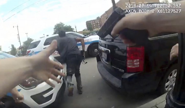 This frame grab from police body cam video provided by the Chicago Police Department shows authorities trying to apprehend a suspect, center, who appeared to be armed, Saturday, July 14, 2018, in Chicago. The suspect was fatally shot by police during the confrontation. (Chicago Police Department via AP)