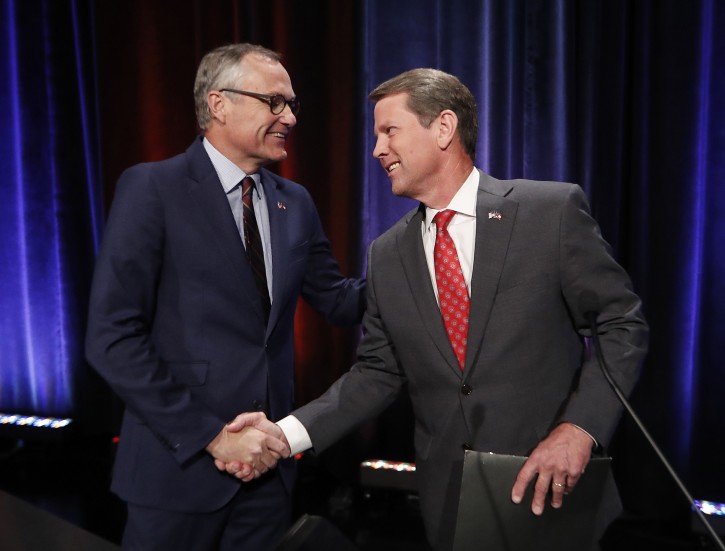FILE - In this July 12, 2018, file photo, Republican candidates for Georgia governor, Lt. Gov. Casey Cagle, left, and Secretary of State Brian Kemp. shake hands after an Atlanta Press Club debate at Georgia Public Television in Atlanta. AP