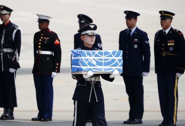A soldier carries a casket containing a remain of a U.S. soldier who were killed in the Korean War during a ceremony at Osan Air Base in Pyeongtaek, South Korea, July 27, 2018.    REUTERS/Kim Hong-Ji/Pool