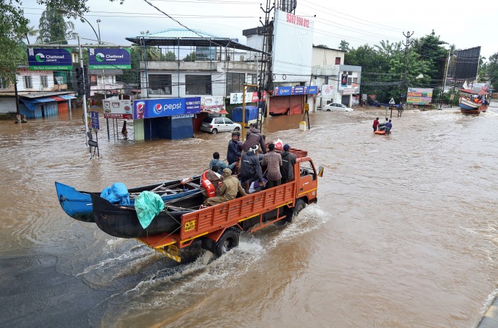 A supply truck transporting boats to flooded areas moves through a water-logged road in Aluva in the southern state of Kerala, India, August 18, 2018. REUTERS/Sivaram V