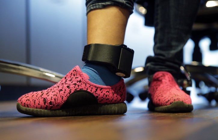 In this Monday, July 23, 2018, file photo, Immigrant seeking asylum Ildra Medreano wears an ankle monitor at a Catholic Charities facility not long after she was reunited with her son in San Antonio. Federal authorities' shift away from separating immigrant families crossing into the U.S. illegally now means that many parents and children are quickly released from custody only to be fitted with electronic monitoring devices, a practice that has spiked in recent years but which both the government and advocacy groups oppose for different reasons. (AP Photo/Eric Gay)