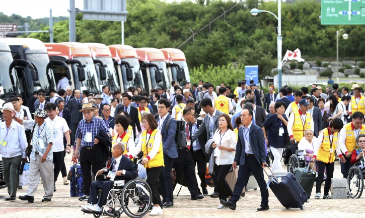 South Koreans leave for North Korea to take part in family reunions with their North Korean family members at the customs, immigration and quarantine, or CIQ office, in Goseong, South Korea, Monday, Aug. 20, 2018. About 200 South Koreans and their family members prepared to cross into North Korea on Monday for heart-wrenching meetings with relatives most haven't seen since they were separated by the turmoil of the Korean War. (Korea Pool/Yonhap via AP)