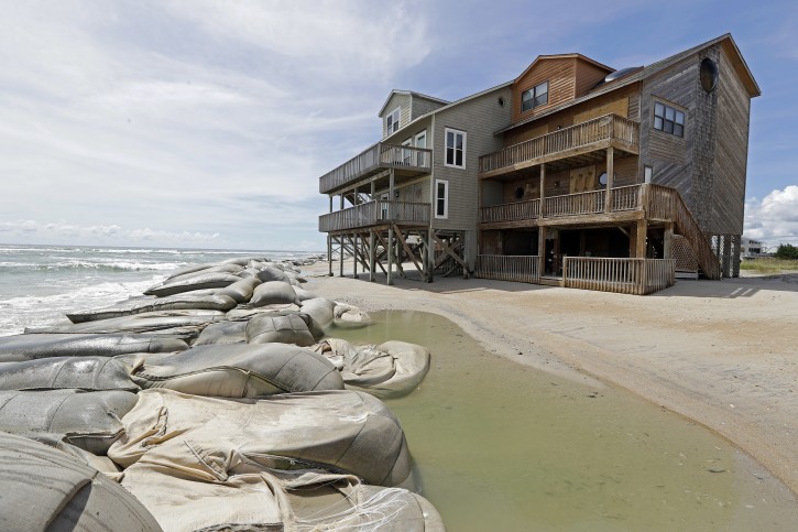 Sand bags aren't enough to stop the water from homes on North Topsail Beach, N.C., Wednesday, Sept. 12, 2018 .AP