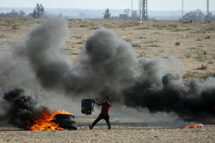 Palestinian protesters clash with Israeli troops near the Gaza-Israel border, east of the southern Gaza Strip city of Rafah, on Sept. 21, 2018.  EPA